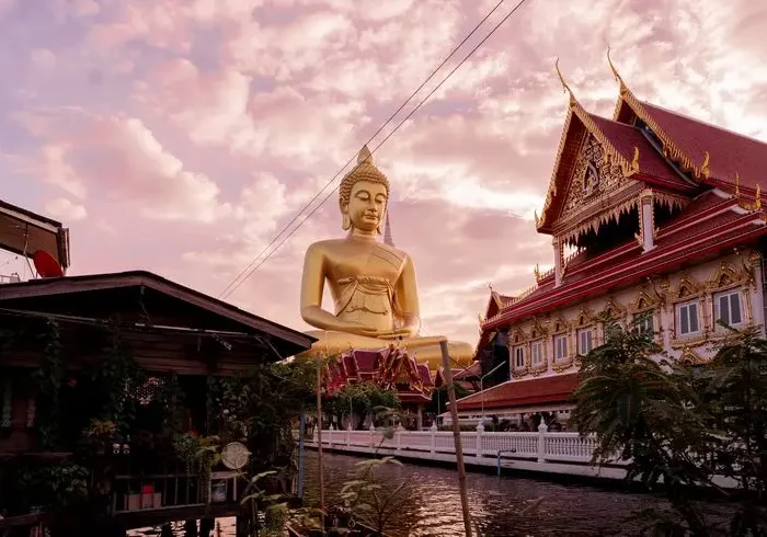 Estátua de Buda junto a um templo em Bangkok, Tailândia