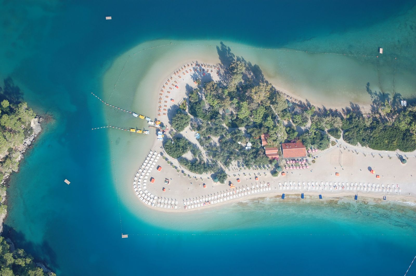 Vista aérea da faixa de areia e vegetação entre águas turquesas em Ölüdeniz, na região de Fethiye.